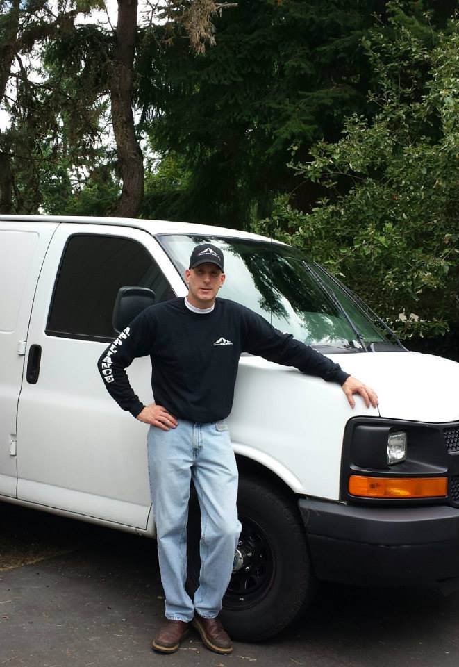 The owner of Advanced Appliance Solutions posing with his van