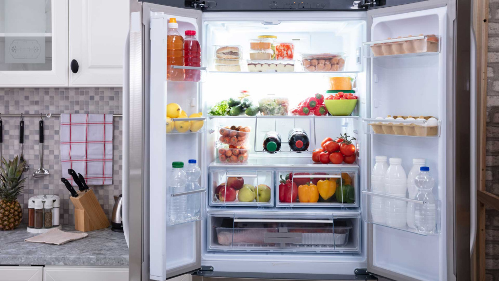 Open refrigerator, full of groceries